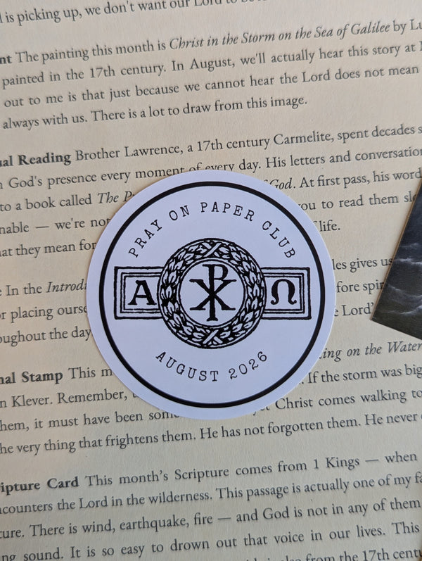 Contents of the August Pray on Paper Catholic prayer subscription envelope, themed around the Presence of God, including sacred art and a scripture card